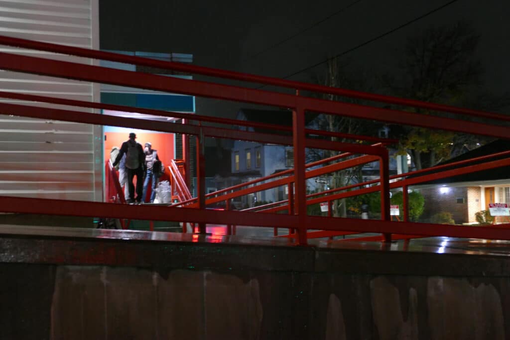 Three youth wait for access to a shelter bed for the night.