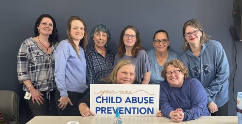 Waypoint staff members wearing blue in support of Child Abuse Prevention Month, with one team member holding a sign that reads 'You are Child Abuse Prevention' — Waypoint, New Hampshire