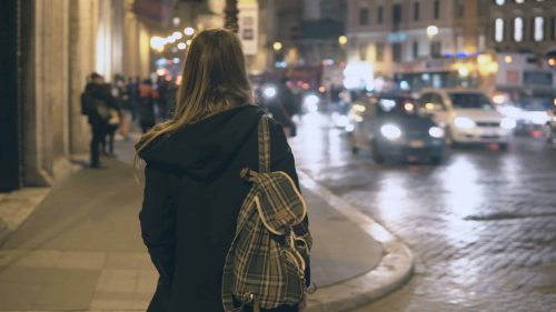 Young,Traveling,Woman,With,Backpack,Crossing,The,Traffic,Road,,Tourist