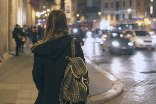 Young,Traveling,Woman,With,Backpack,Crossing,The,Traffic,Road,,Tourist