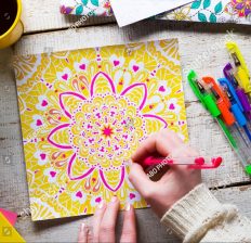 stock-photo-woman-coloring-an-adult-coloring-book-new-stress-relieving-trend-mindfulness-concept-hand-detail-376339795